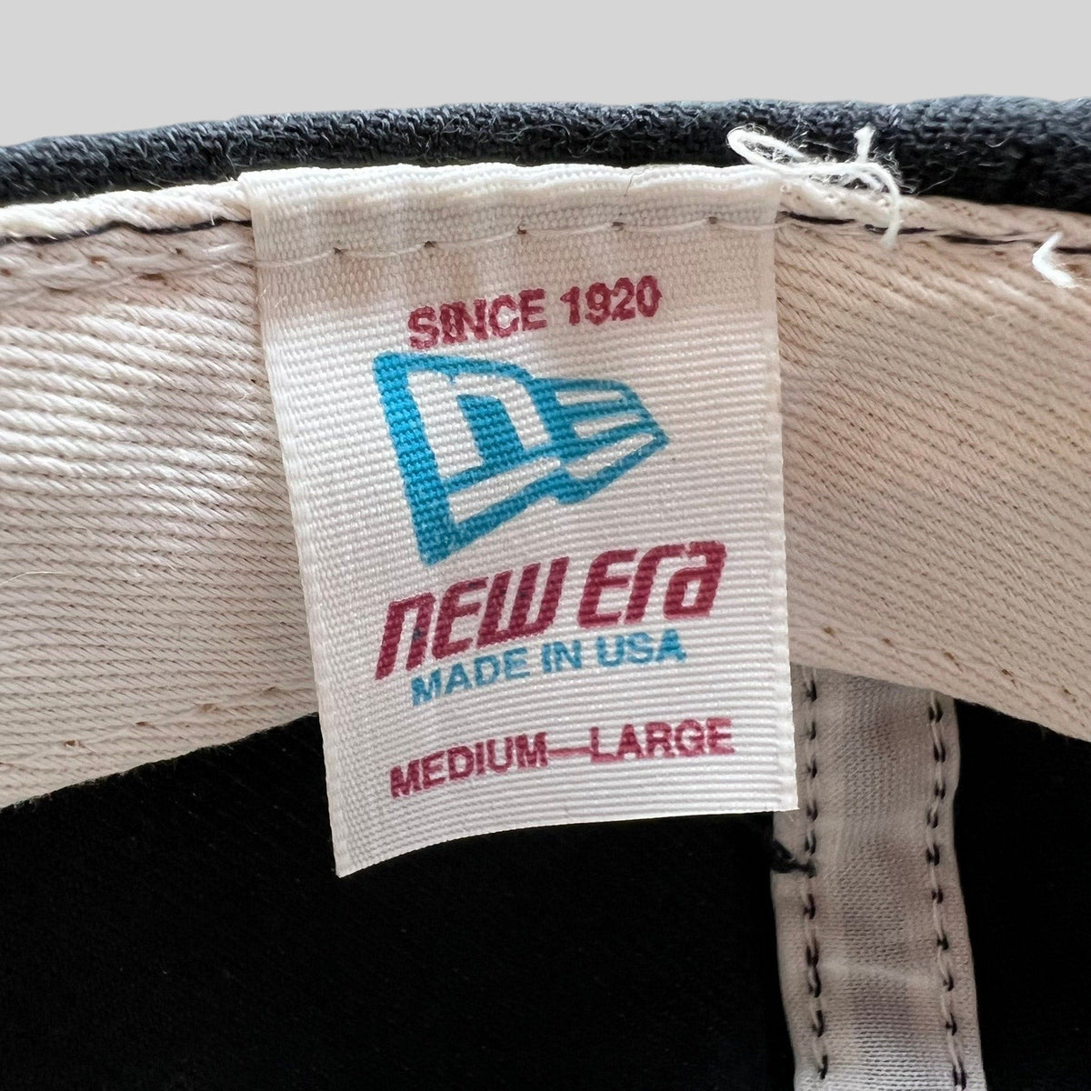 Raree Finds vintage New Era cap interior label showing Made in USA and Medium-Large sizing