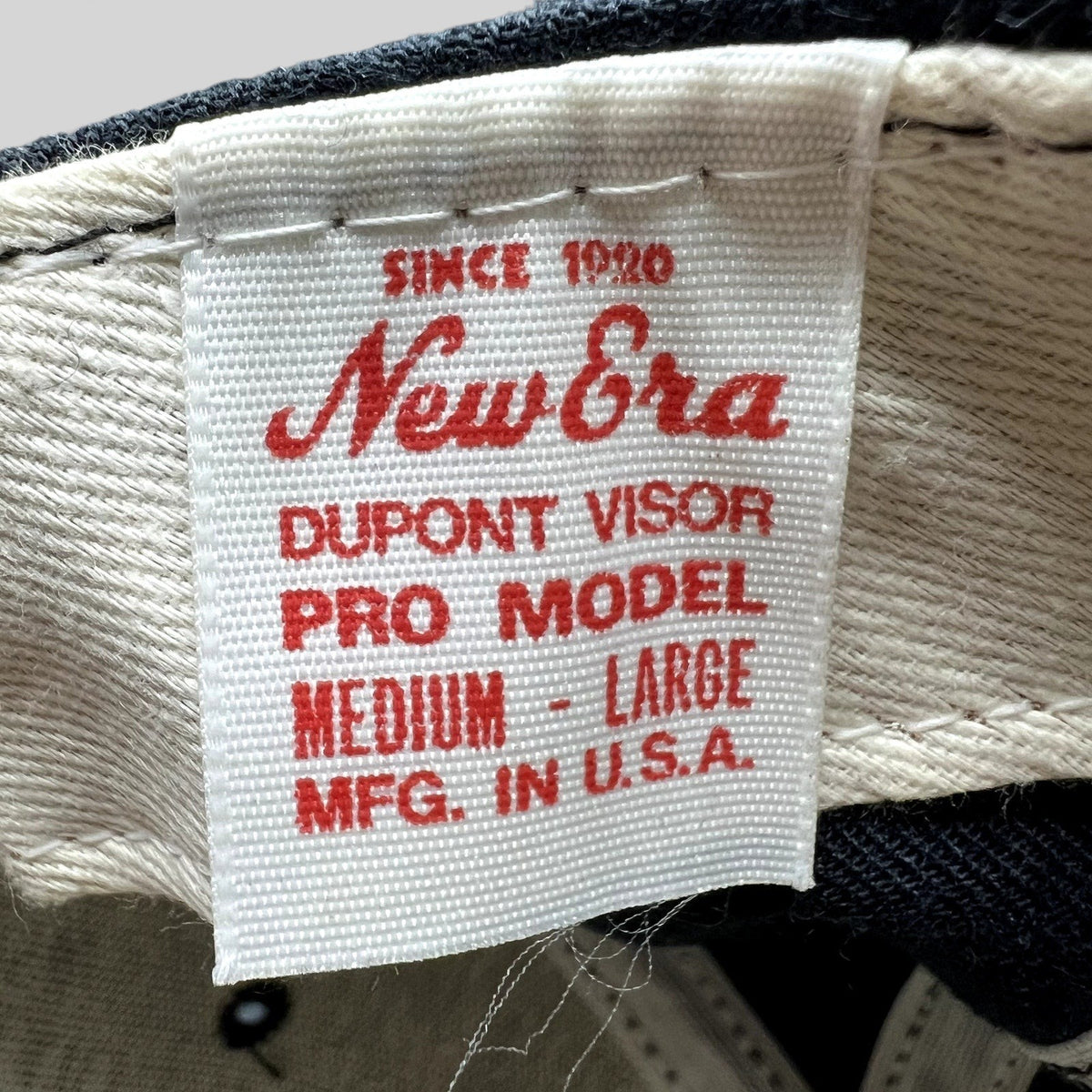 Raree Finds vintage New Era DuPont hat interior tag showing Made in USA and Pro Model details