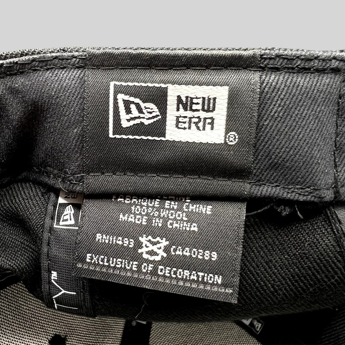 Raree Finds New Era hat interior label showing 100 percent wool material and manufacturing details