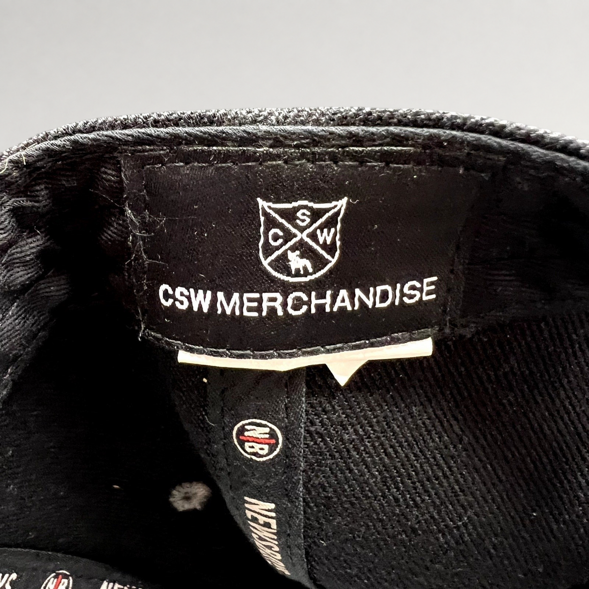 Raree Finds Newsboys Love Riot tour hat interior label showing CSW Merchandise branding and custom interior taping