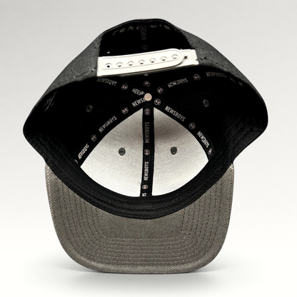 Raree Finds Newsboys Love Riot snapback hat interior showing branded taping, adjustable closure, and gray flat brim.