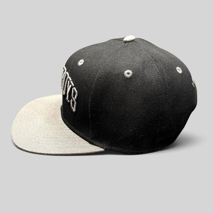 Raree Finds Newsboys Love Riot snapback hat in black and gray with 3D embroidered lettering and a flat brim.