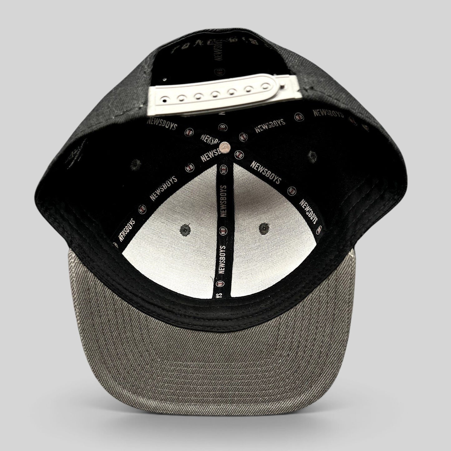 Raree Finds Newsboys Love Riot snapback hat interior showing custom branded taping and adjustable plastic closure
