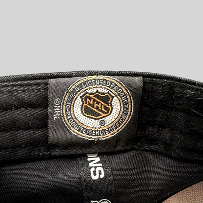 Raree Finds vintage 2002 Detroit Red Wings NHL licensed merchandise tag inside a black New Era strapback hat