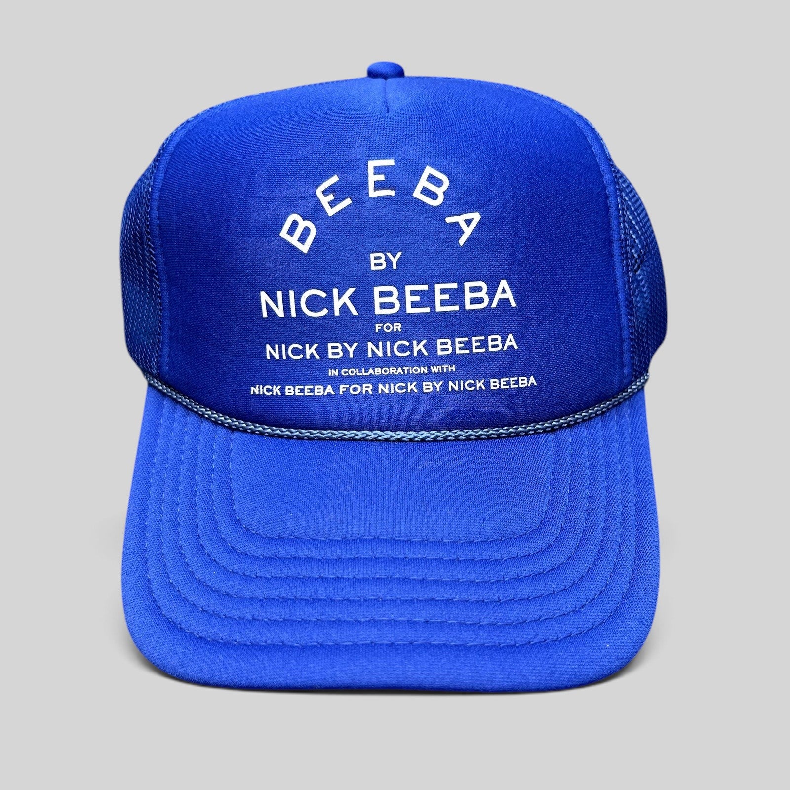 Raree Finds royal blue Otto foam trucker hat with white Nick Beeba promotional graphic and snapback closure.