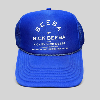 Raree Finds royal blue Otto foam trucker hat with white Nick Beeba promotional graphic and snapback closure.