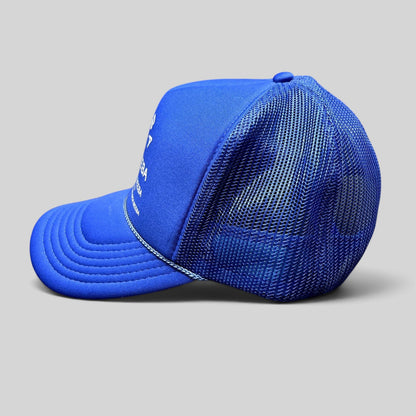 Raree Finds royal blue Nick Beeba foam front trucker hat with mesh back and white graphic text, side profile view.