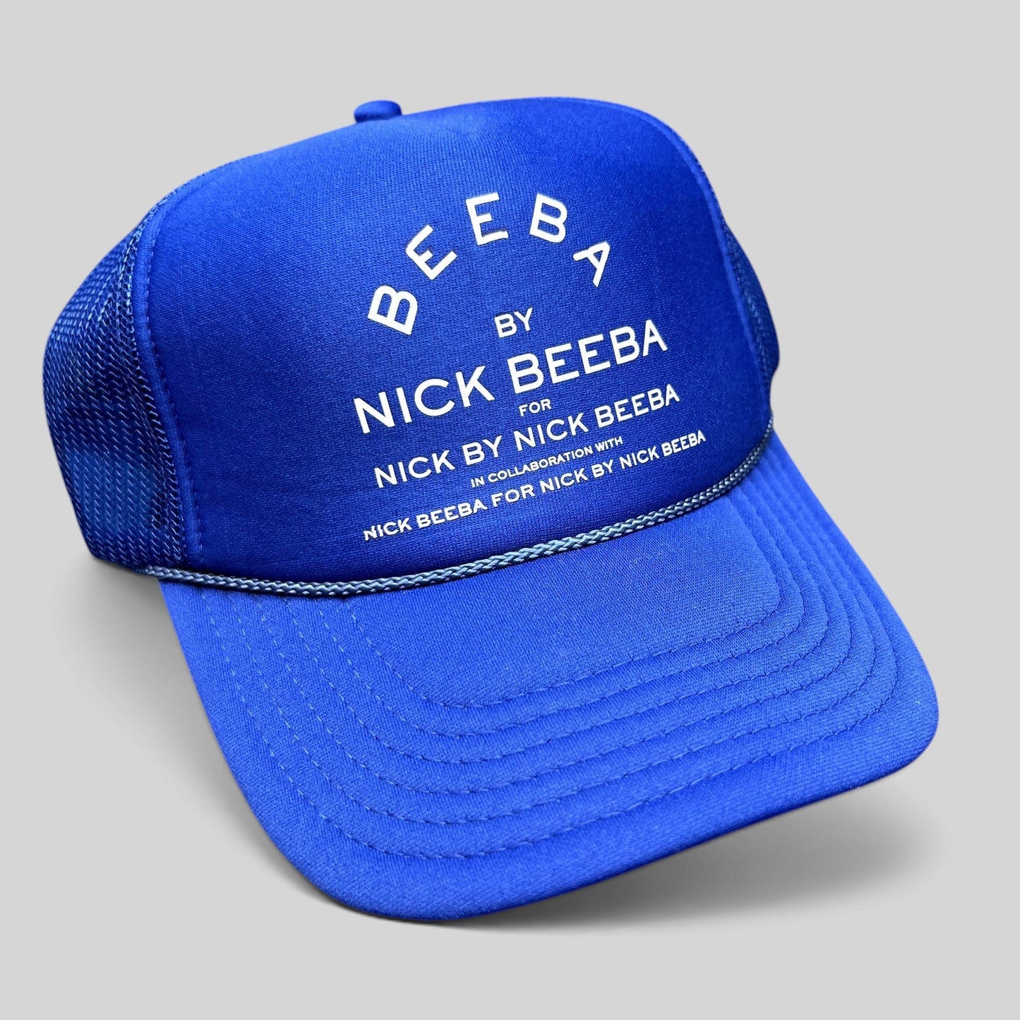 Raree Finds royal blue Otto foam-front trucker hat with white Nick Beeba promotional graphic and mesh back