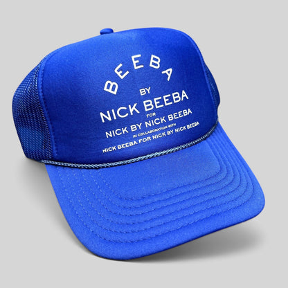 Raree Finds royal blue Otto foam-front trucker hat with white Nick Beeba promotional graphic and mesh back