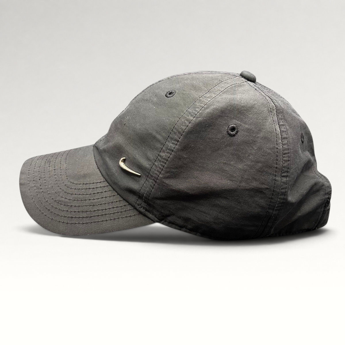 Raree Finds Nike Heritage 86 black unstructured strapback hat with a small metallic silver Swoosh logo on the front.