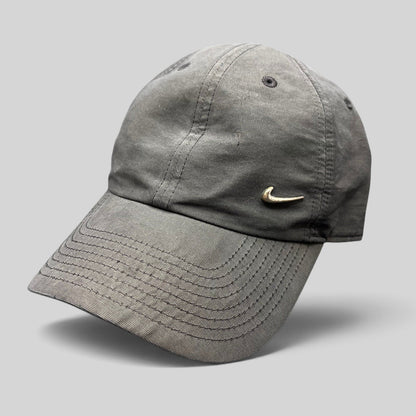 Raree Finds black Nike Heritage 86 unstructured strapback hat with a small metallic silver Swoosh logo