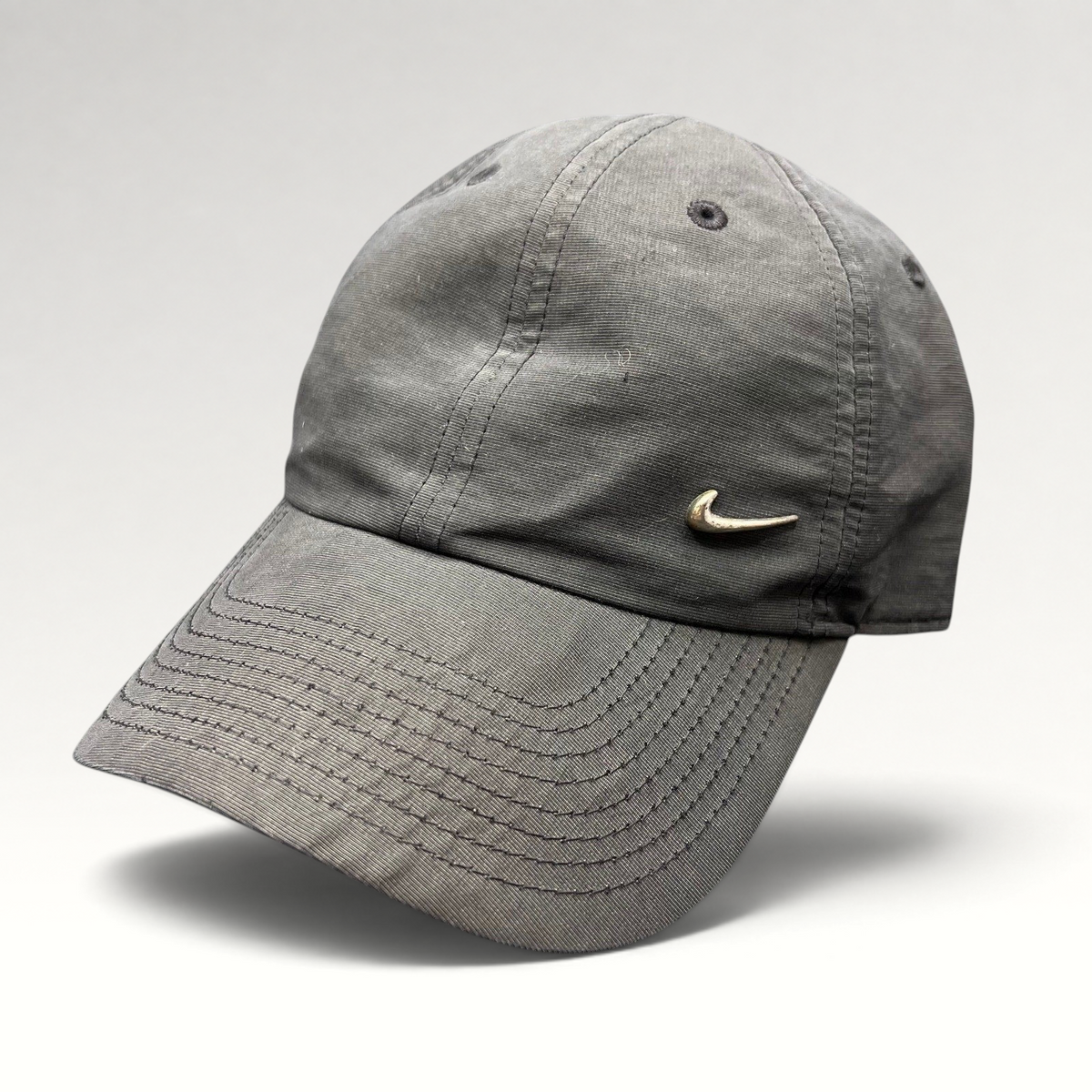 Raree Finds black Nike Heritage 86 unstructured strapback hat with a small metallic silver Swoosh logo
