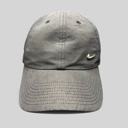 Raree Finds Nike Heritage 86 black unstructured strapback hat with a small metallic silver Swoosh logo on the front.