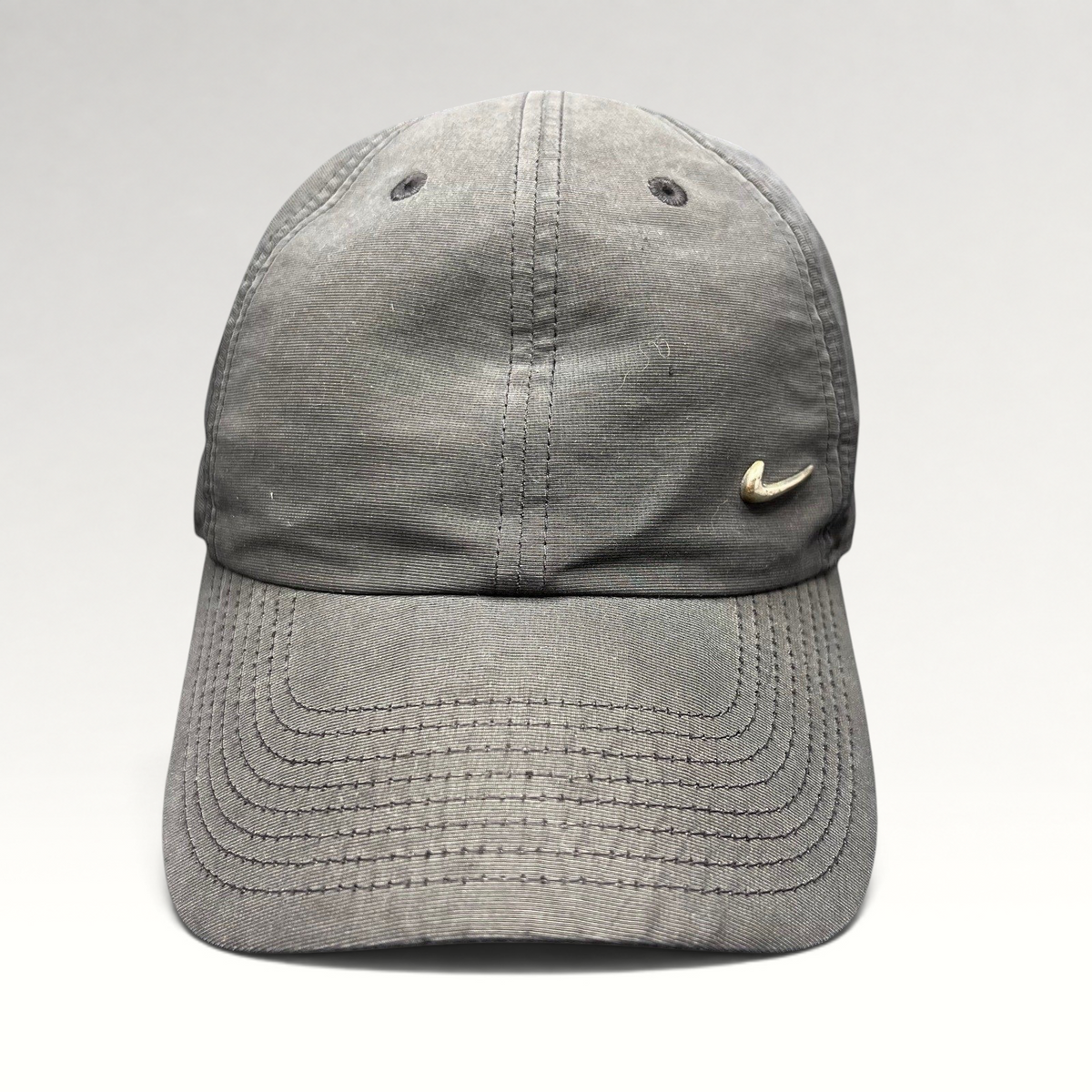 Raree Finds Nike Heritage 86 black unstructured strapback hat with a small metallic silver Swoosh logo on the front.