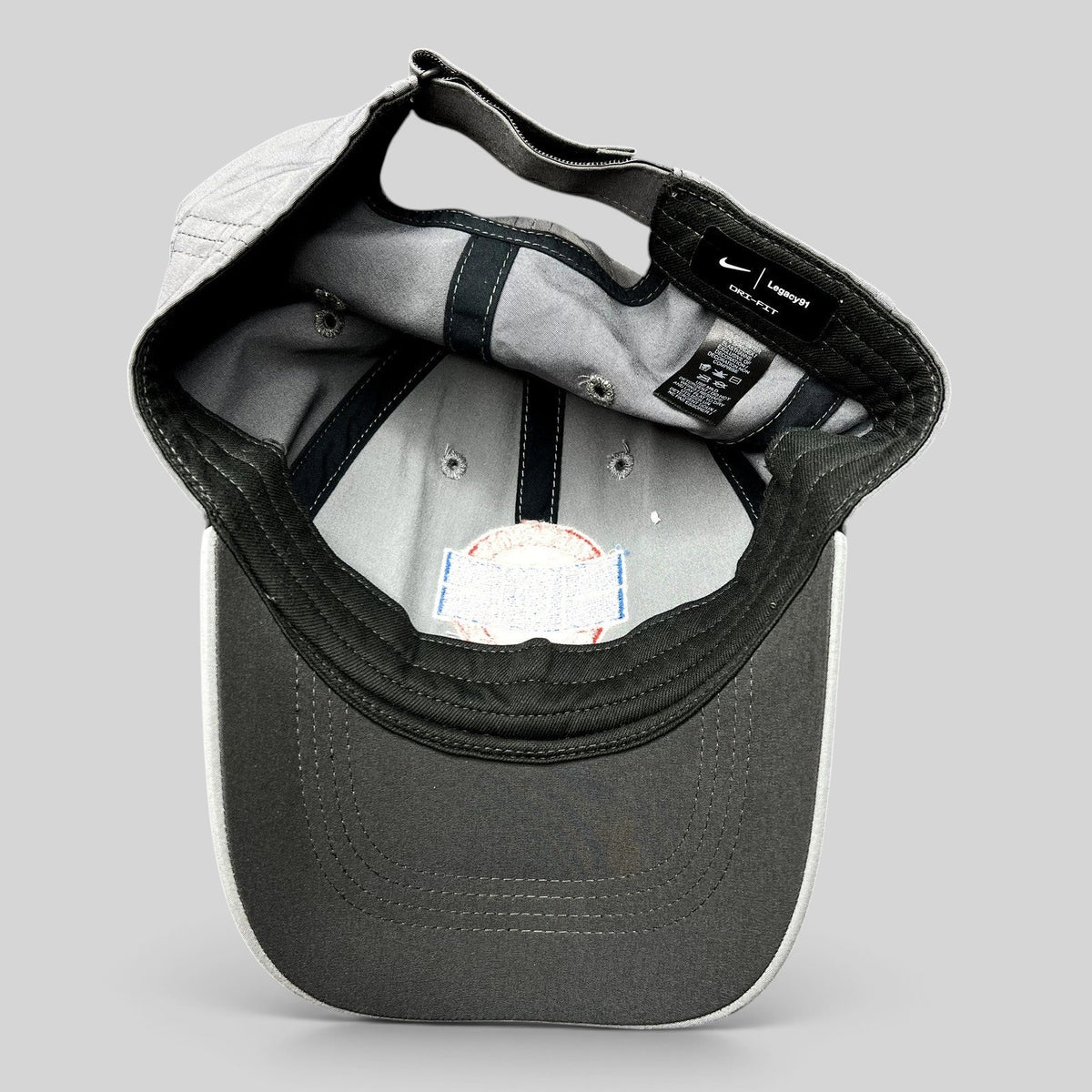 Raree Finds Nike Dri-FIT Legacy91 gray tennis hat interior showing moisture-wicking fabric and adjustable strapback