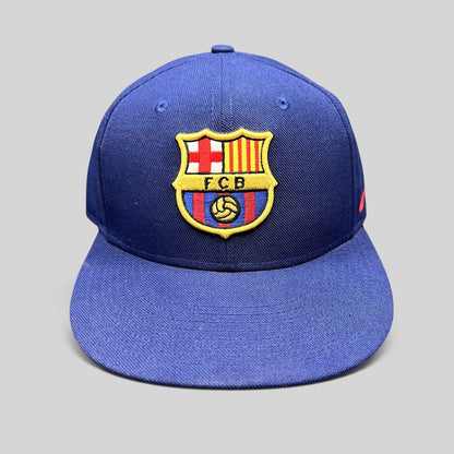 Raree Finds Nike FC Barcelona snapback hat in navy blue with an embroidered FCB crest on the front and flat brim.