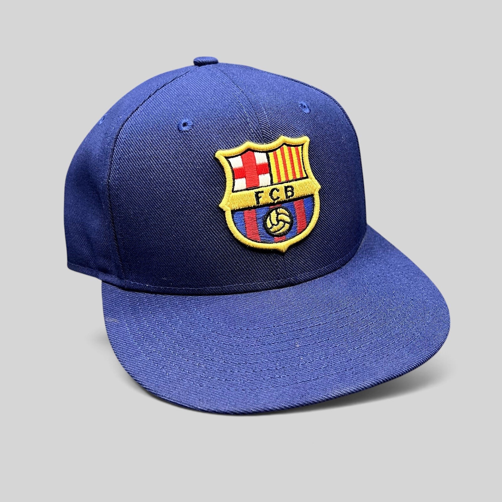 Raree Finds navy blue Nike True FC Barcelona snapback hat with an embroidered FCB crest on the front and flat brim.