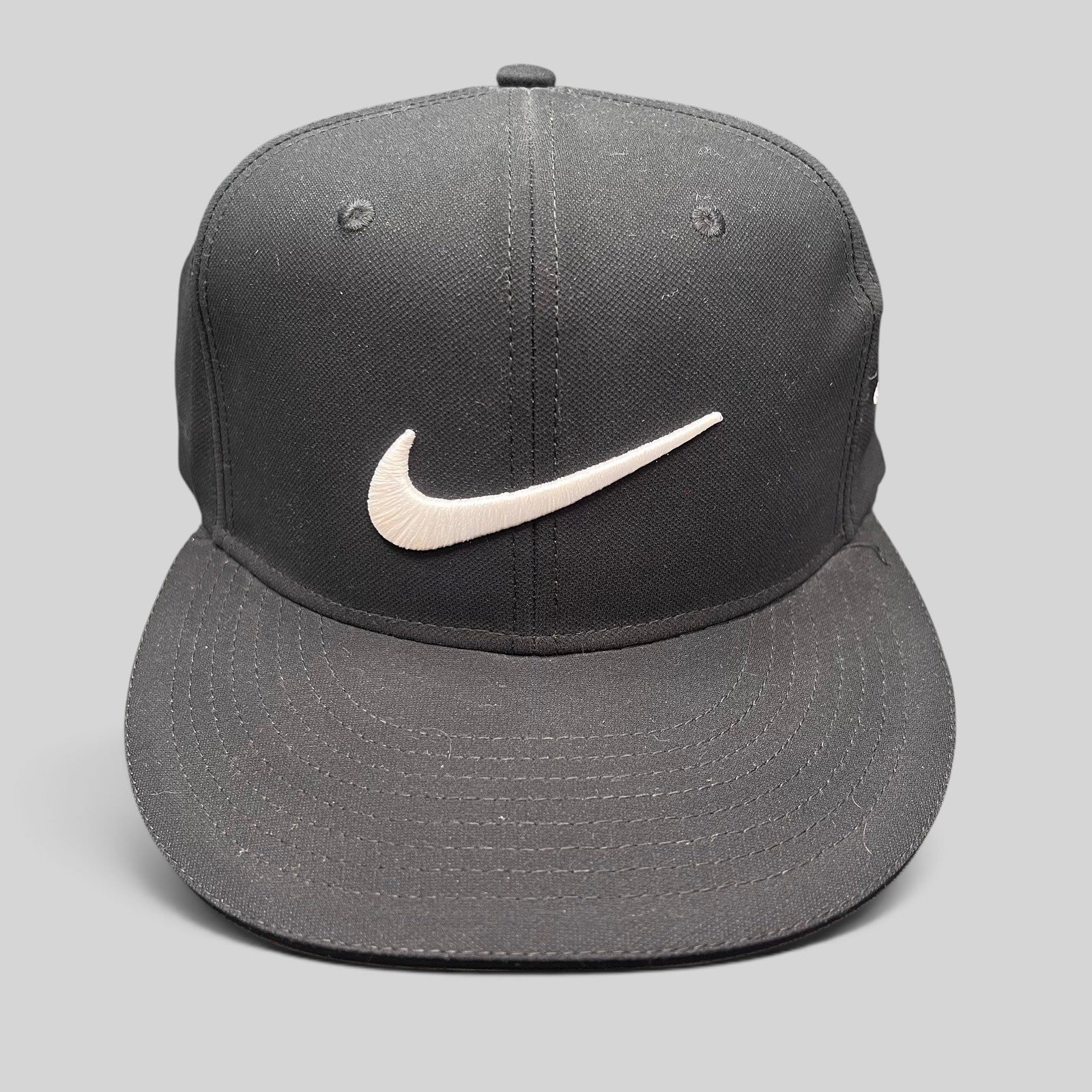 Raree Finds black Nike Golf fitted cap with white embroidered Swoosh logo and flat brim