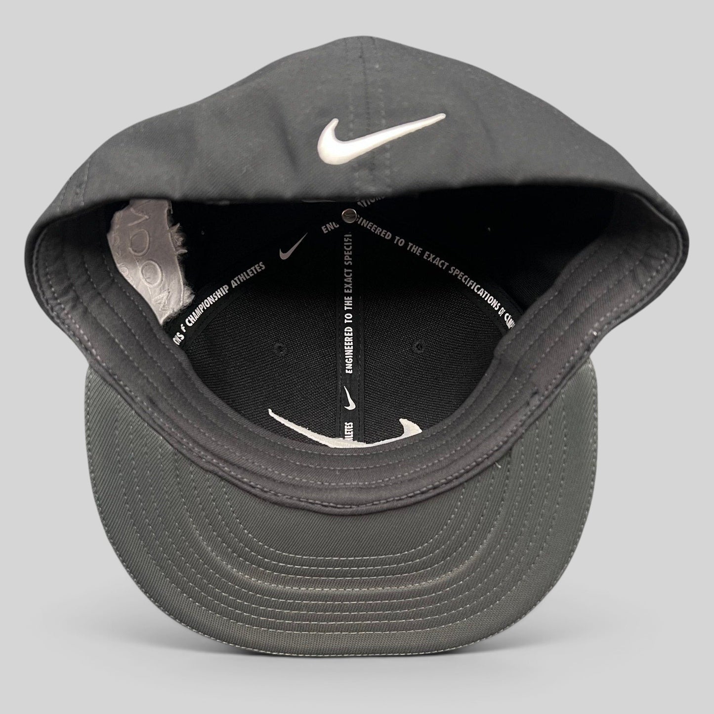 Raree Finds Nike Golf black fitted cap with white Swoosh logo and interior performance taping