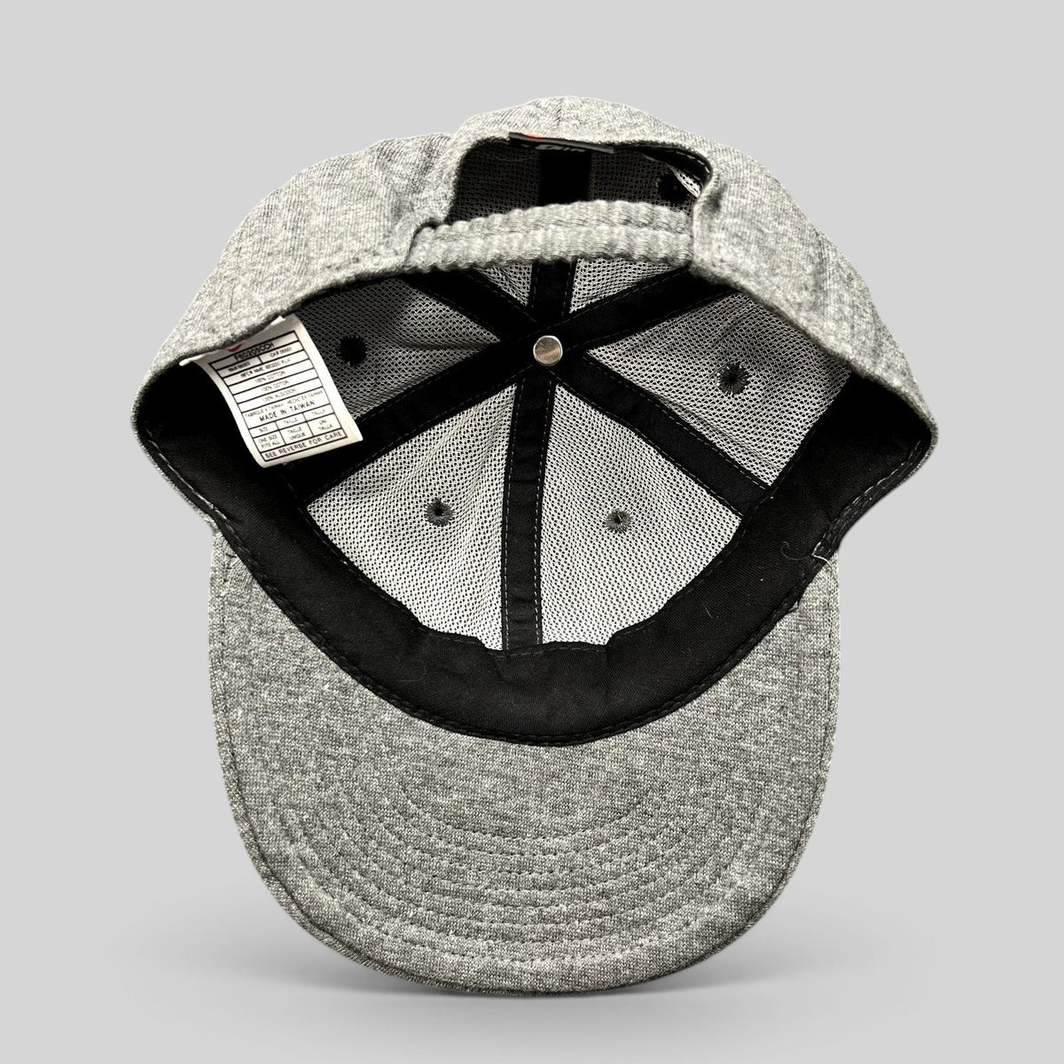 Raree Finds vintage Nike heather gray cotton strapback hat showing interior mesh lining and care tag