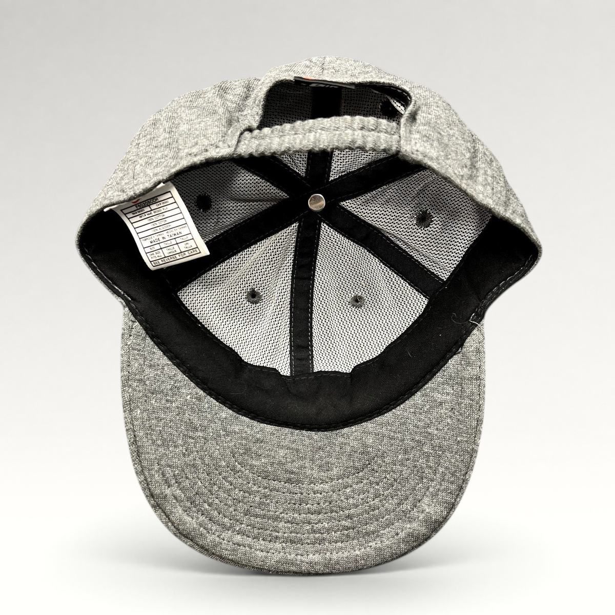 Raree Finds vintage Nike heather gray cotton strapback hat showing interior mesh lining and care tag
