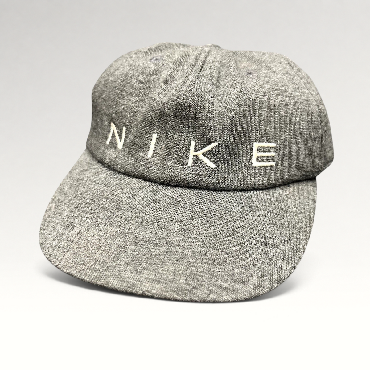 Raree Finds vintage Nike heather gray cotton strapback hat with minimalist white embroidered spellout logo