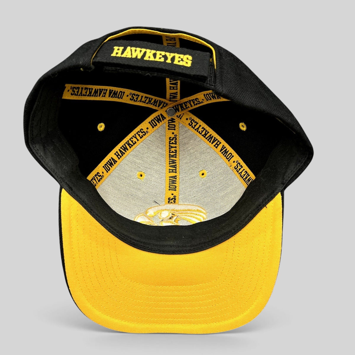 Raree Finds vintage Nike Iowa Hawkeyes strapback hat showing interior branded taping and gold embroidery on black