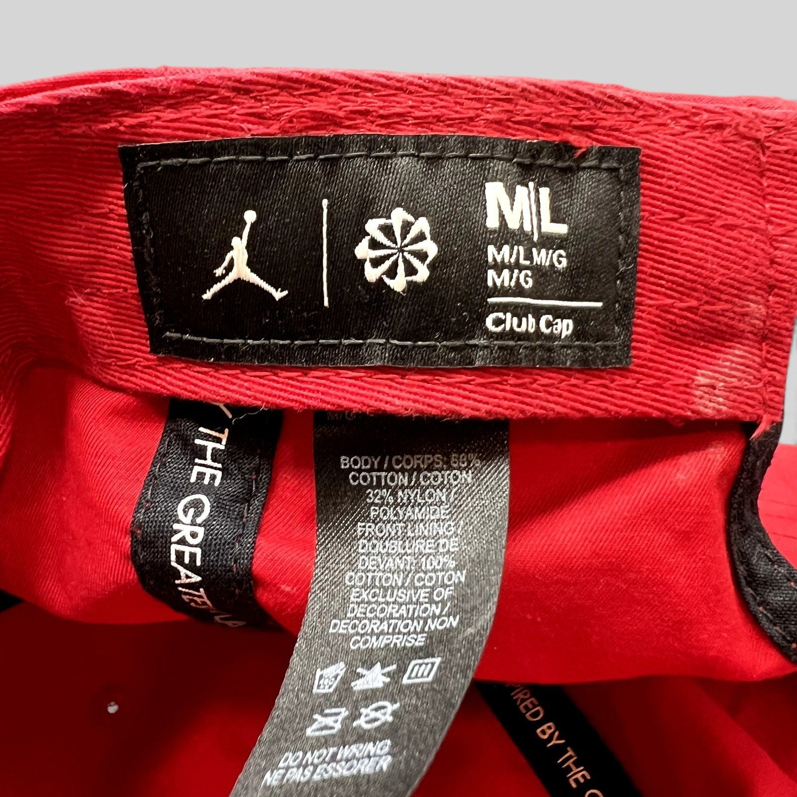 Raree Finds Nike Air Jordan club cap interior tag showing size M/L, material composition, and Jumpman logo branding.