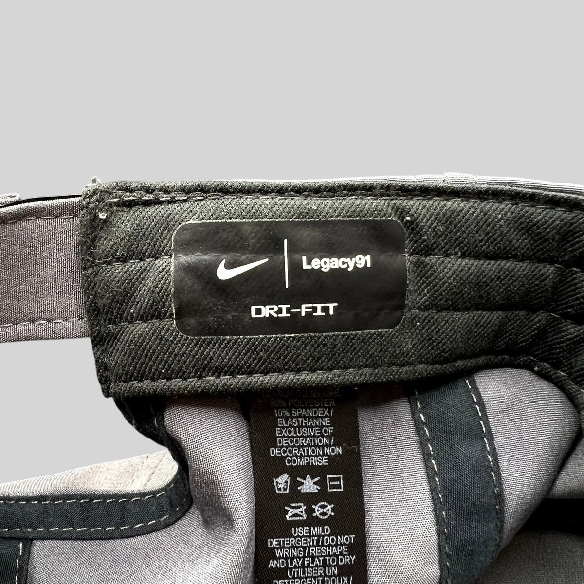 Raree Finds Nike Legacy91 Dri-FIT hat interior tag showing fabric composition and branding details