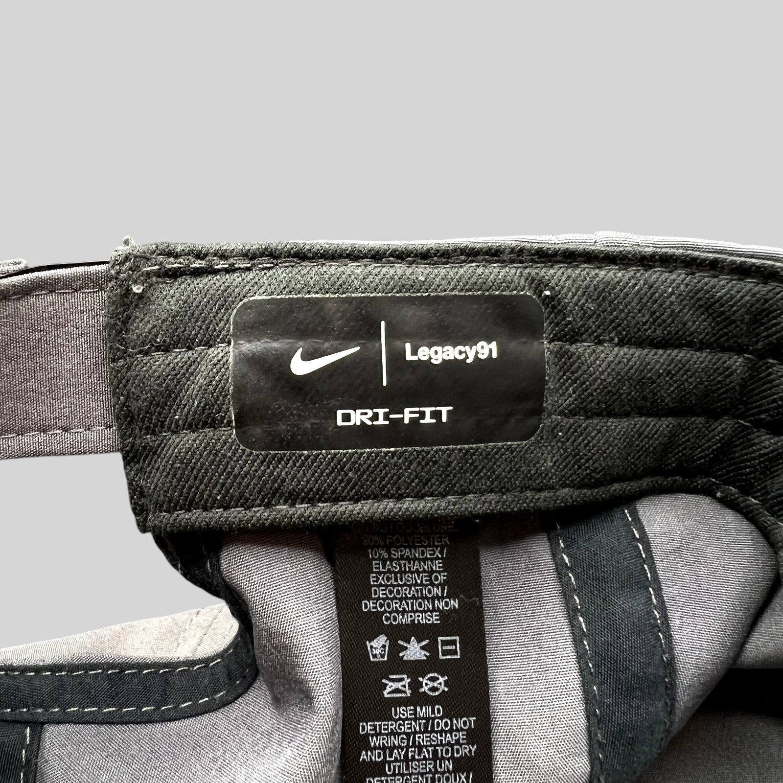 Raree Finds Nike Legacy91 Dri-FIT hat interior tag showing fabric composition and branding details