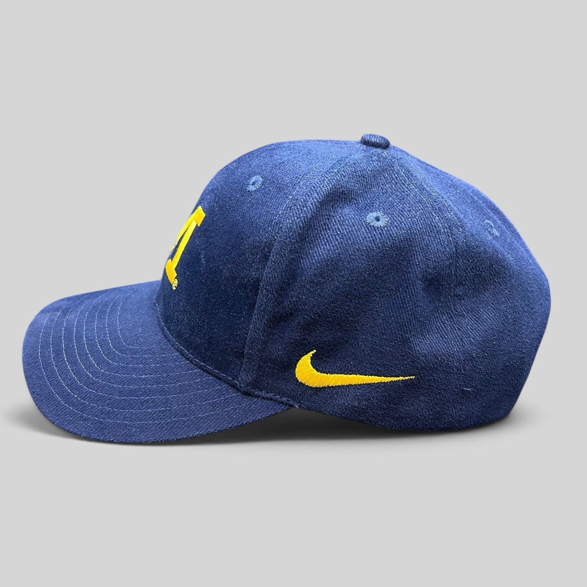 Raree Finds vintage Nike Team Sports Michigan Wolverines navy and maize cotton snapback hat with side swoosh logo