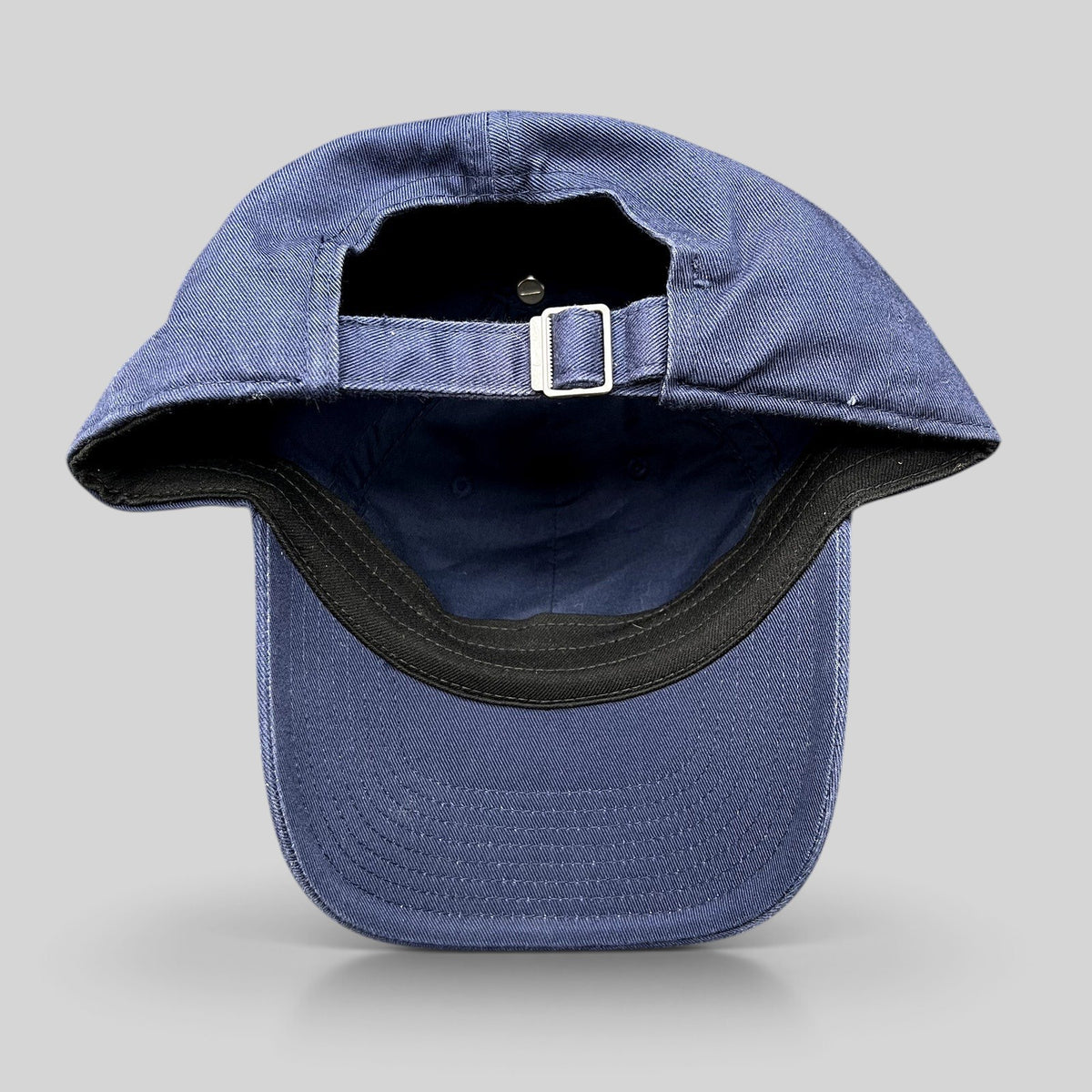 Raree Finds Nike Heritage86 navy blue strapback hat showing the adjustable metal buckle closure and curved brim