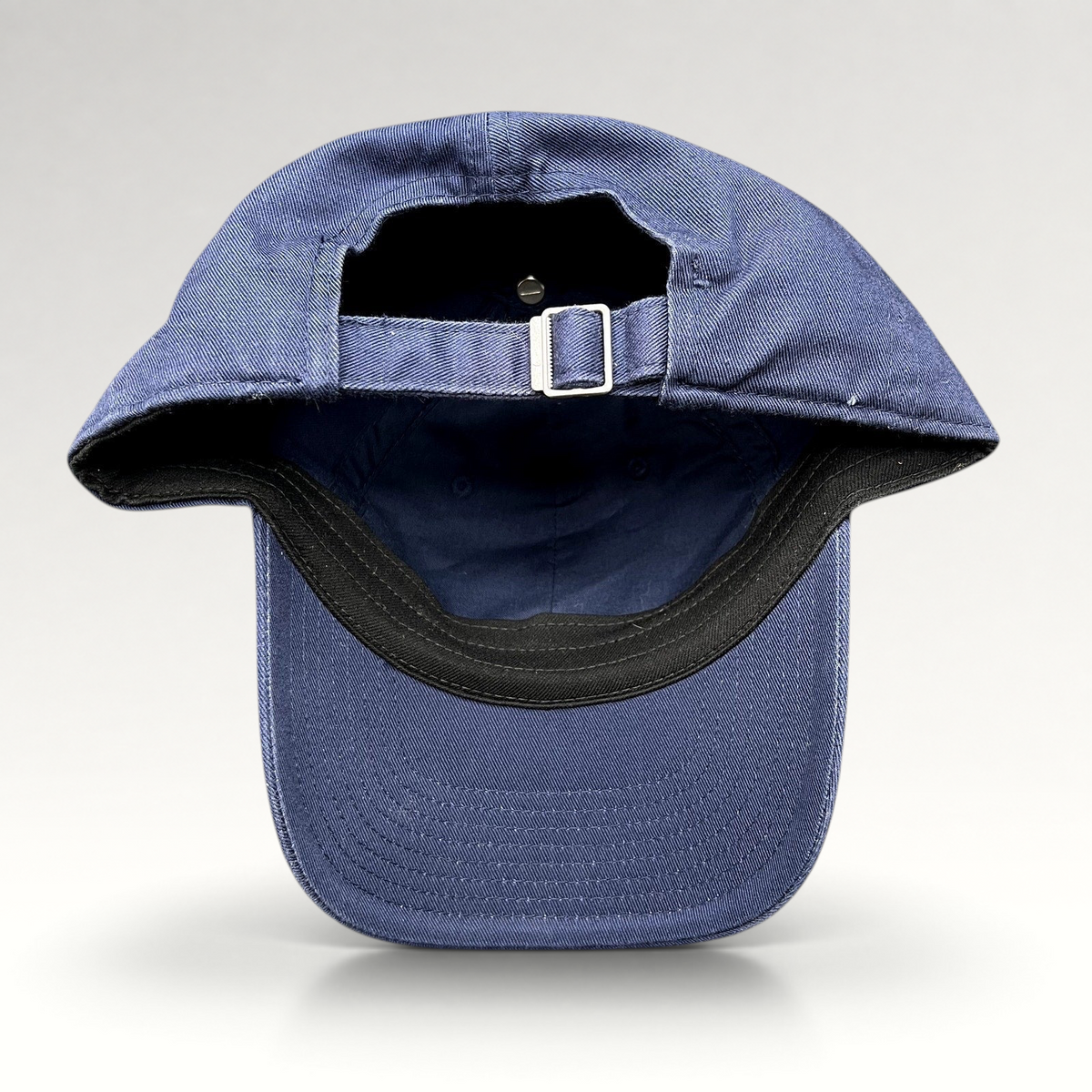 Raree Finds Nike Heritage86 navy blue strapback hat showing the adjustable metal buckle closure and curved brim
