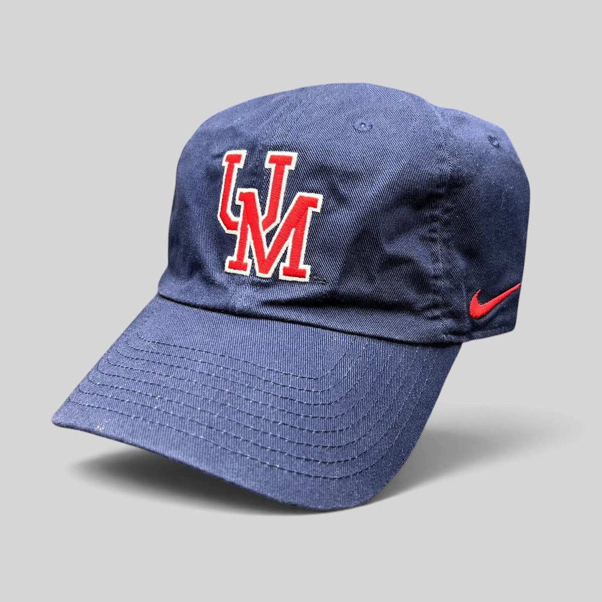 Raree Finds navy blue Nike Heritage86 University of Mobile strapback hat with red and white UM logo and side swoosh.