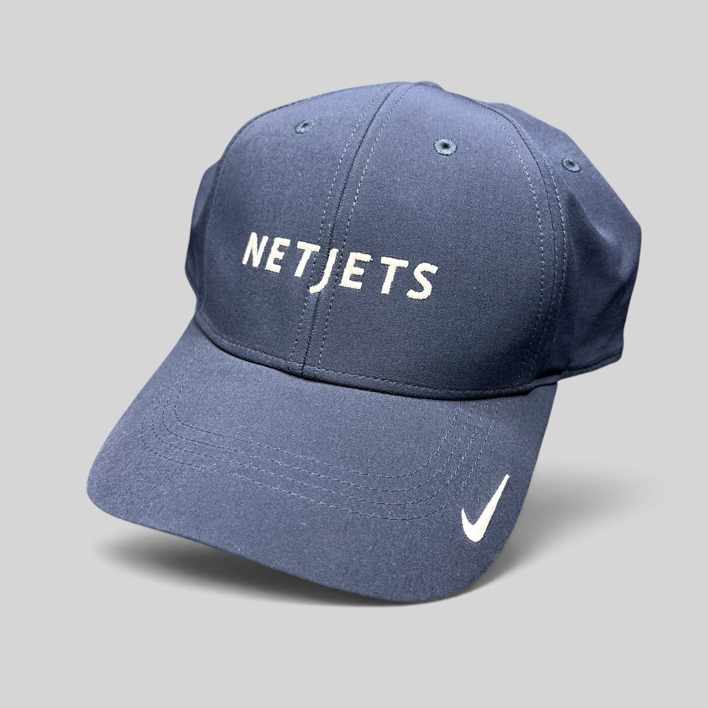Raree Finds navy blue Nike Legacy91 Dri-FIT hat with white embroidered NetJets logo and Nike Swoosh on the brim.