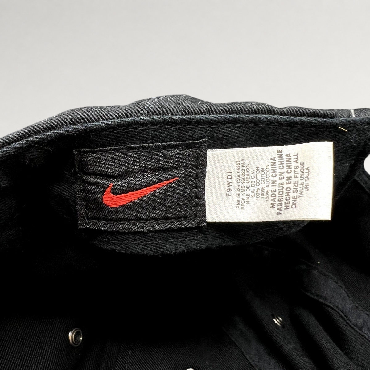 Raree Finds vintage Nike soccer hat interior showing the black cotton fabric, care tag, and red Nike swoosh label.