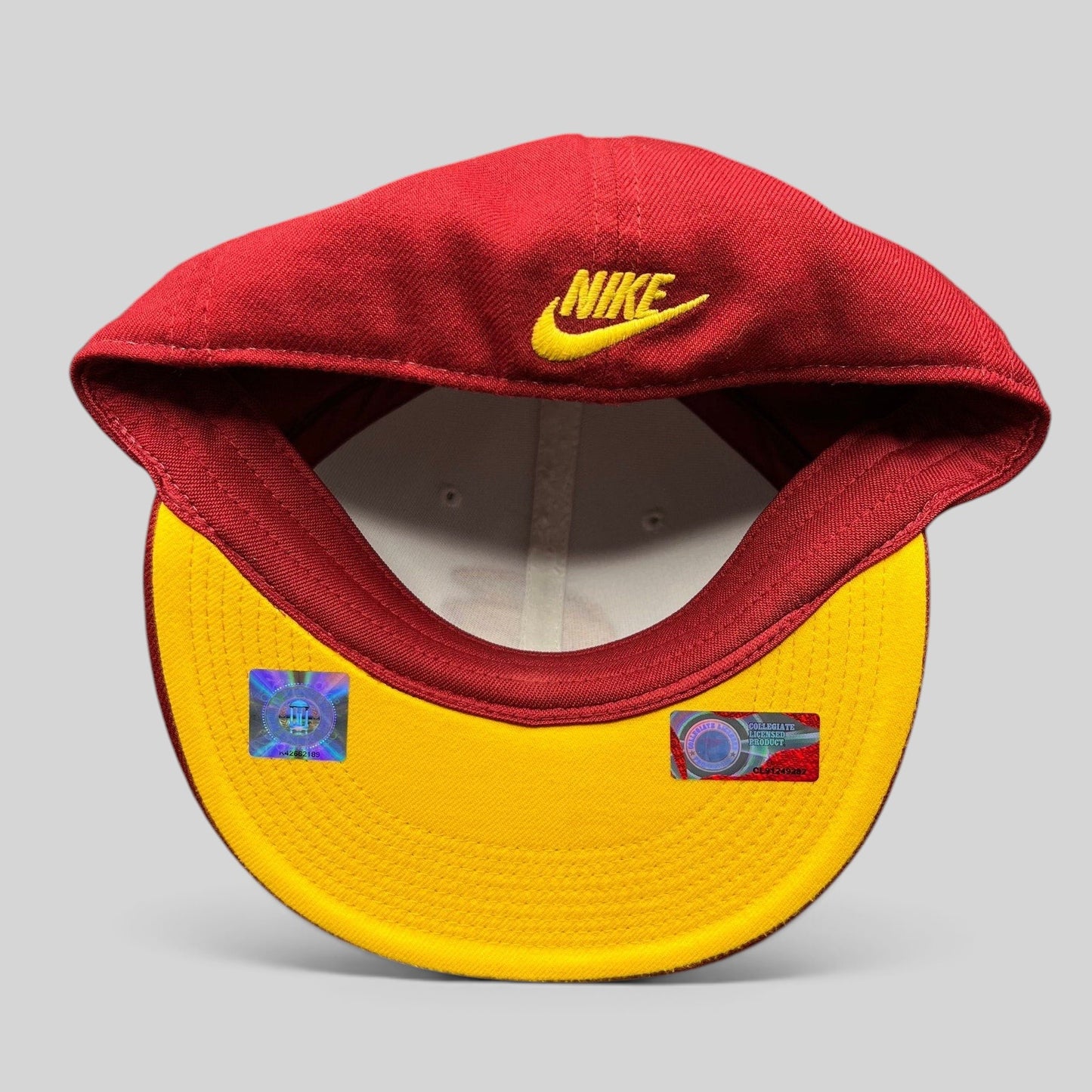 Raree Finds vintage Nike USC Trojans fitted hat with red crown, yellow underbrim, and Nike swoosh embroidery.