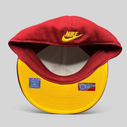 Raree Finds vintage Nike USC Trojans fitted hat with red crown, yellow underbrim, and Nike swoosh embroidery.