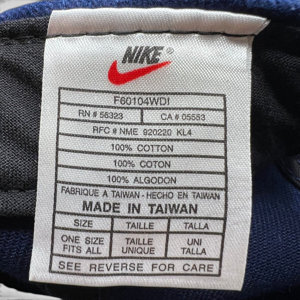 Raree Finds vintage Nike Team Sports hat interior care label showing 100% cotton material and made in Taiwan details.