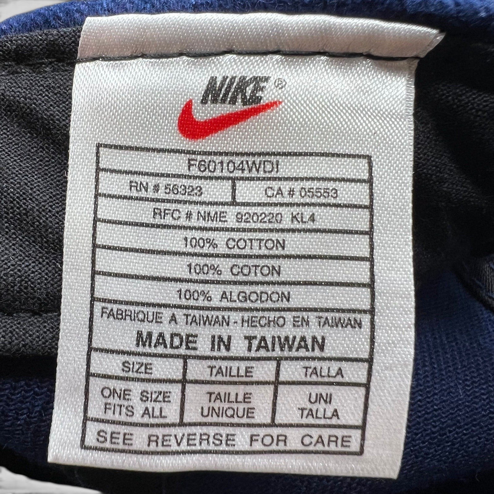 Raree Finds vintage Nike Team Sports hat interior care label showing 100% cotton material and made in Taiwan details.