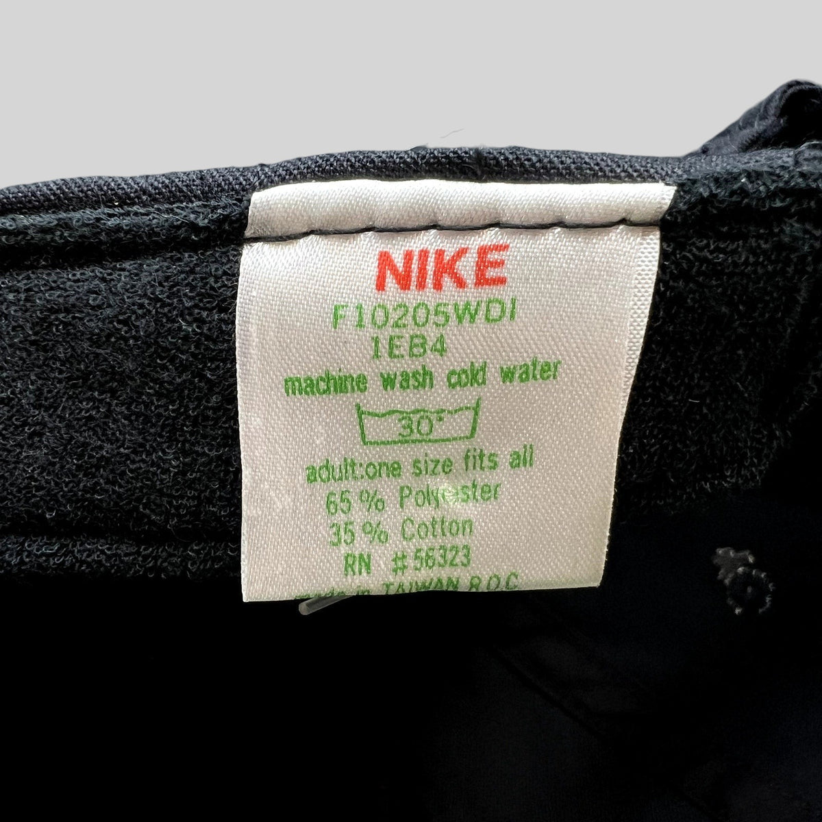 Raree Finds vintage Nike hat care tag showing 65 percent polyester and 35 percent cotton blend made in Taiwan