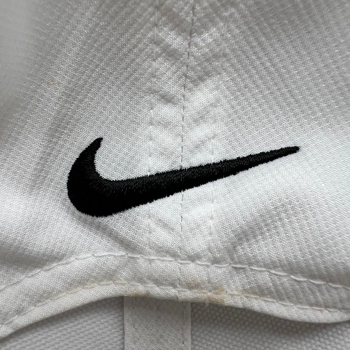 Raree Finds white Nike Legacy 91 performance cap featuring a black embroidered Swoosh logo on the underside of the brim