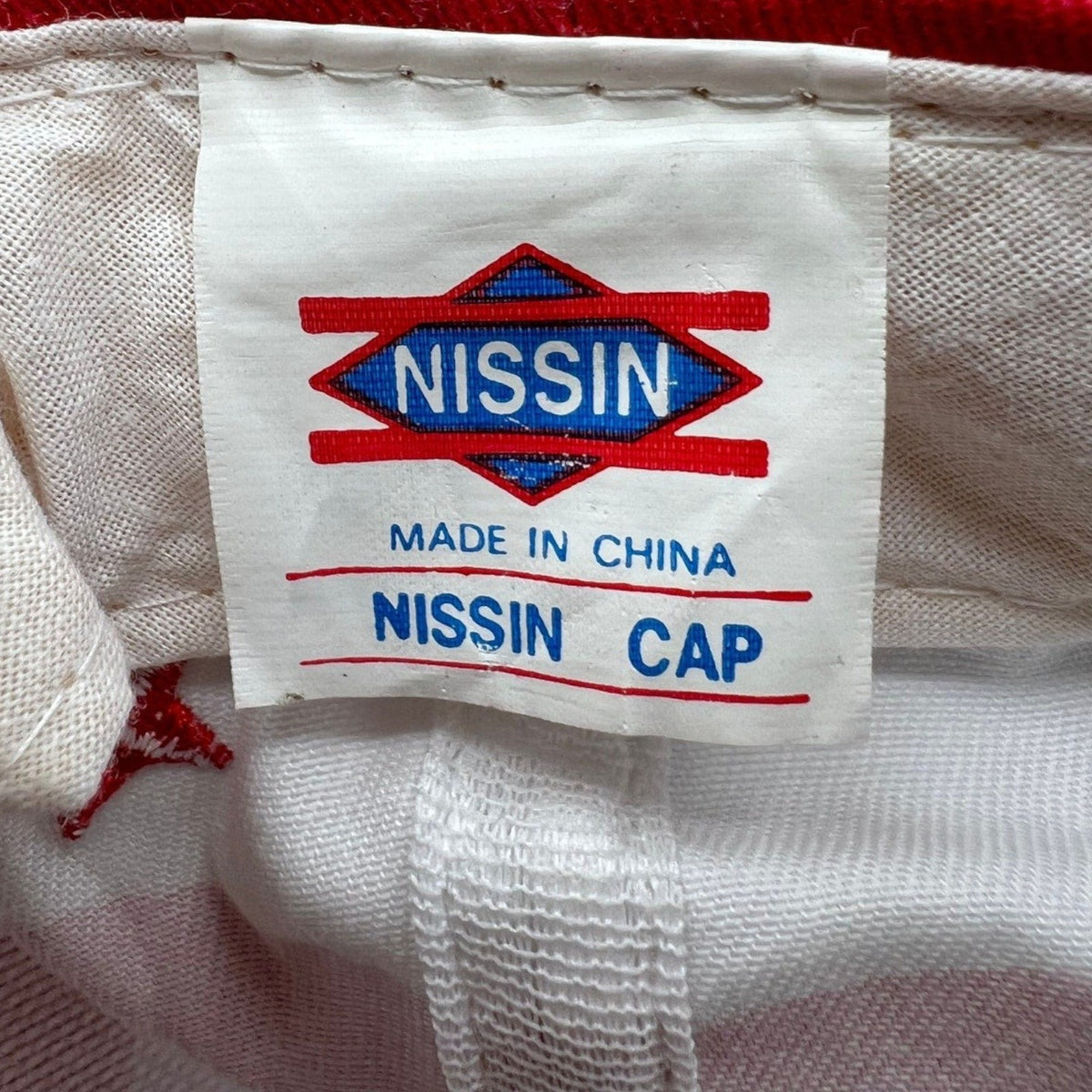 Raree Finds vintage Nissin Cap interior label showing Made in China branding on white cotton fabric