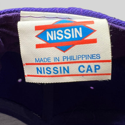 Raree Finds vintage 90s Nissin cap interior label showing brand logo and Made in Philippines text on purple fabric
