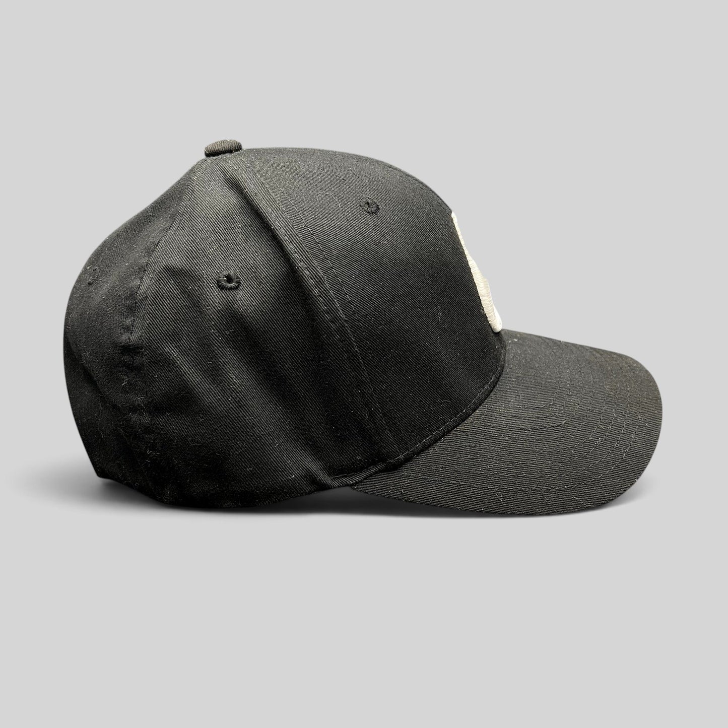Raree Finds black Nixon Watches fitted cap with white embroidered logo on a comfortable Flexfit stretch crown