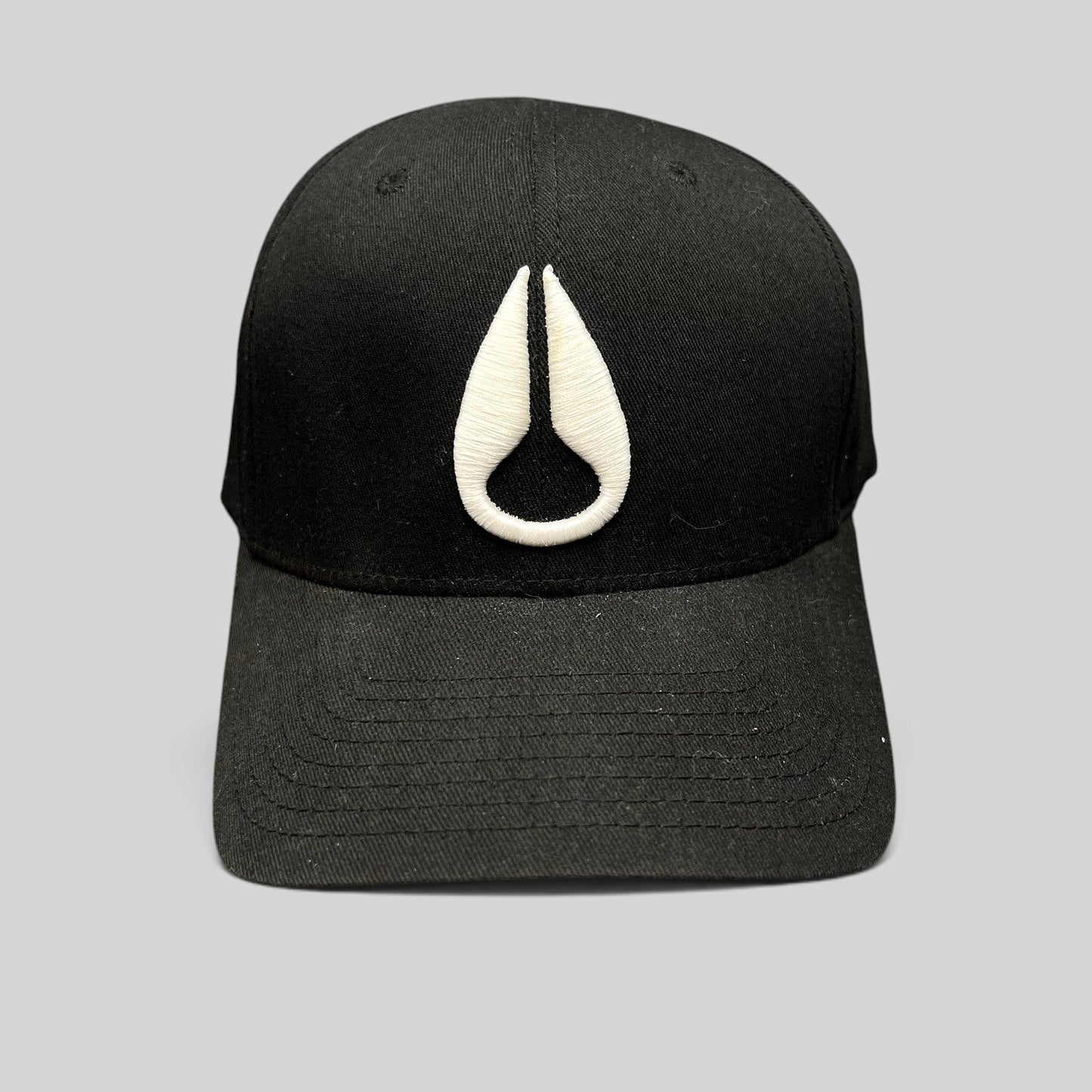 Raree Finds black Flexfit cap featuring a white embroidered Nixon droplet logo on the front crown