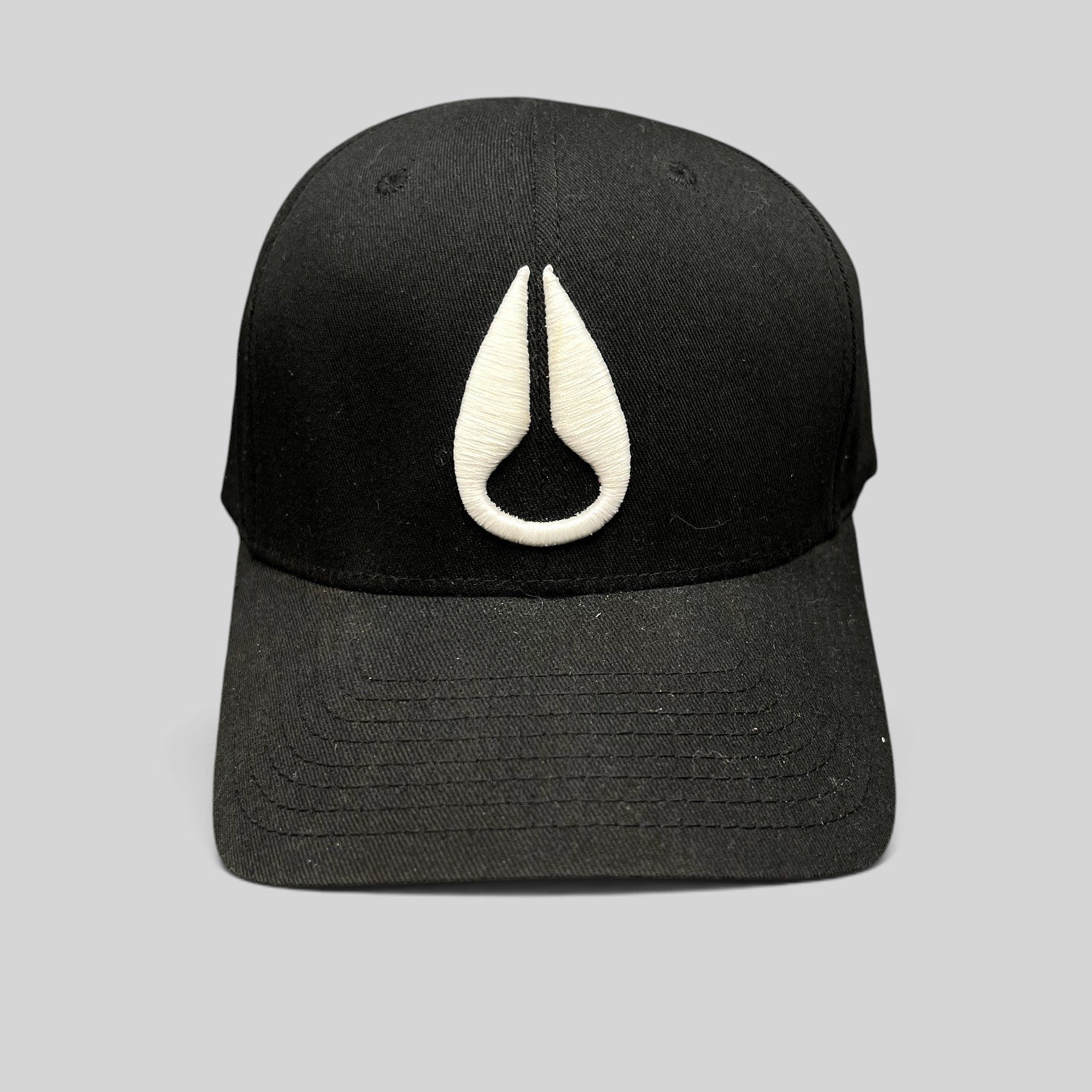 Raree Finds black Flexfit cap featuring a white embroidered Nixon droplet logo on the front crown