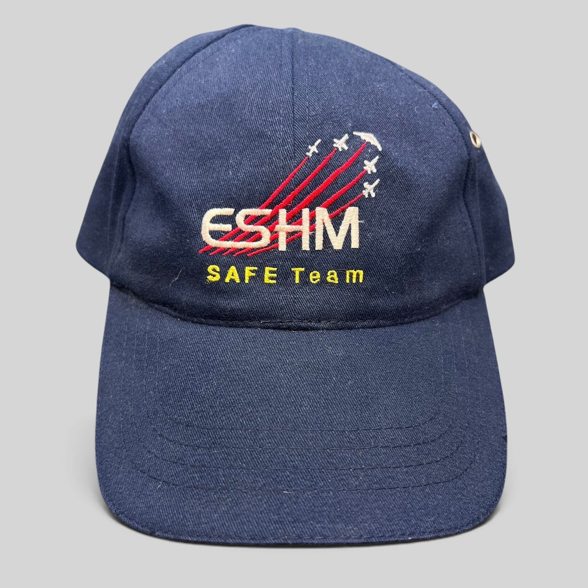 Raree Finds vintage navy blue cotton Northrop Grumman ESHM SAFE Team strapback hat with embroidered aircraft graphics.