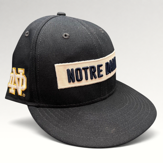 Raree Finds black New Era 9FIFTY snapback hat with cream Notre Dame wordmark patch and side logo embroidery