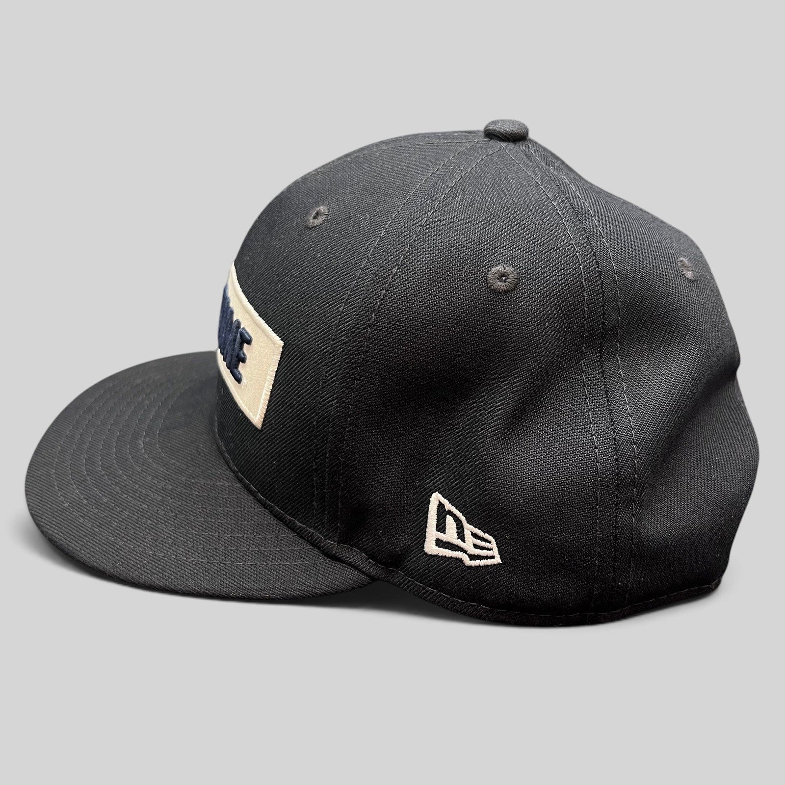 Raree Finds black New Era 9FIFTY Notre Dame snapback hat with a cream rectangular wordmark patch and flat brim.